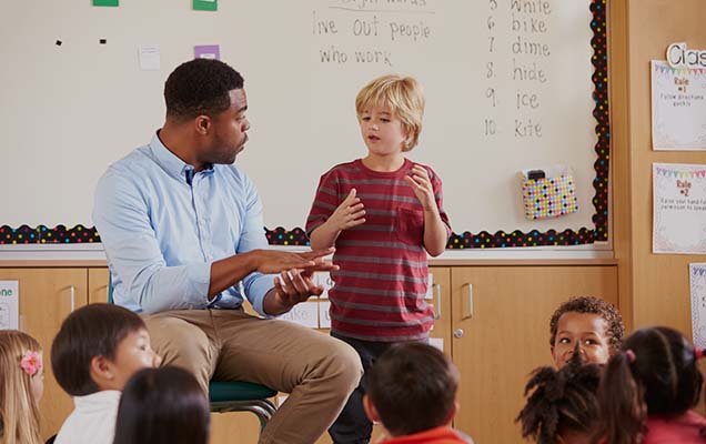 teacher speaking to his class using the knowledge gained with his Online Special Education Degree